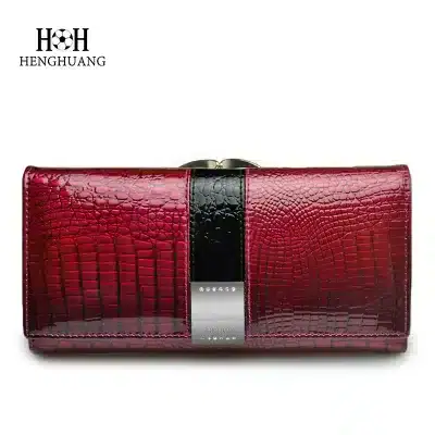 Luxurious red crocodile-embossed wallet with sleek black and silver accents, perfect for stylish women seeking high-quality accessories.
