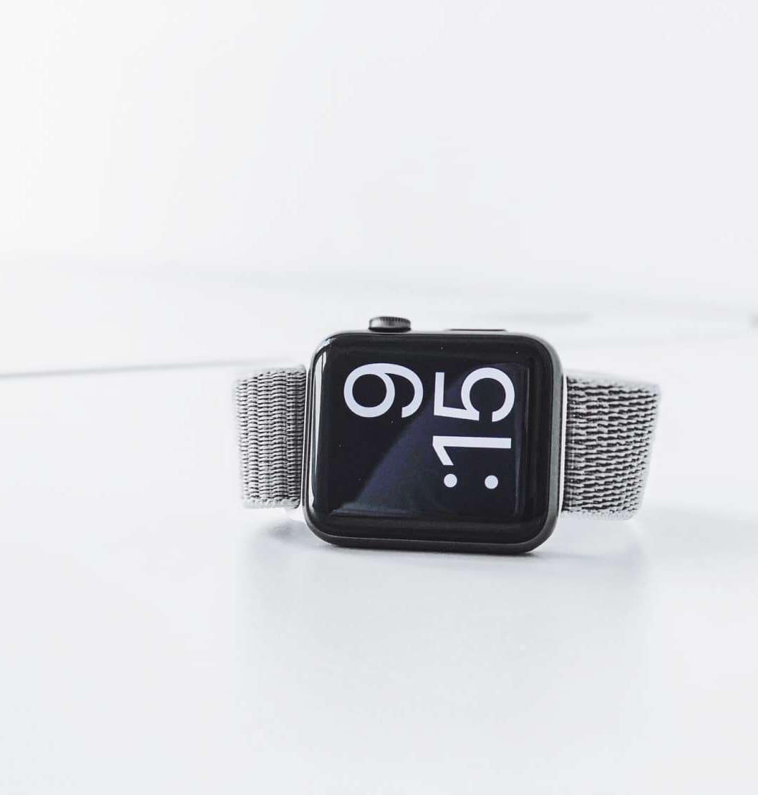 Alt text: Modern smartwatch with a sleek design, black screen, and silver mesh band, displaying the time 9:15, ideal for health and fitness enthusiasts.