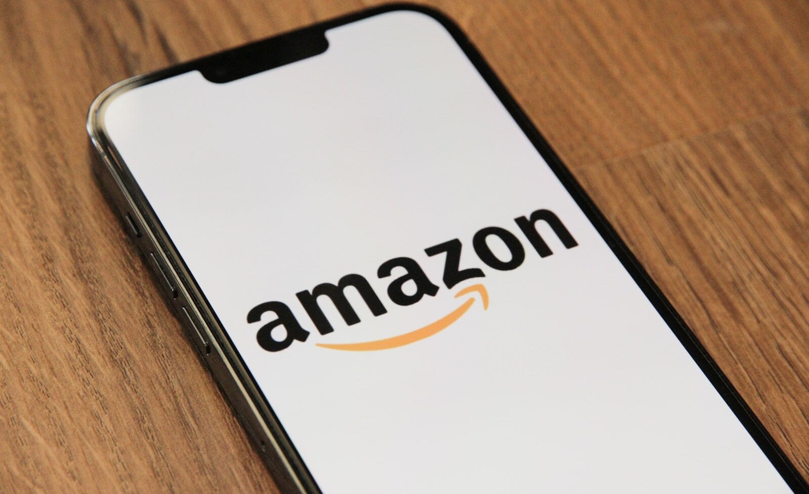 Amazon logo on phone, representing online shopping for healthcare products, telehealth, medical supplies, and pharmacy services available through Monalisa Store.