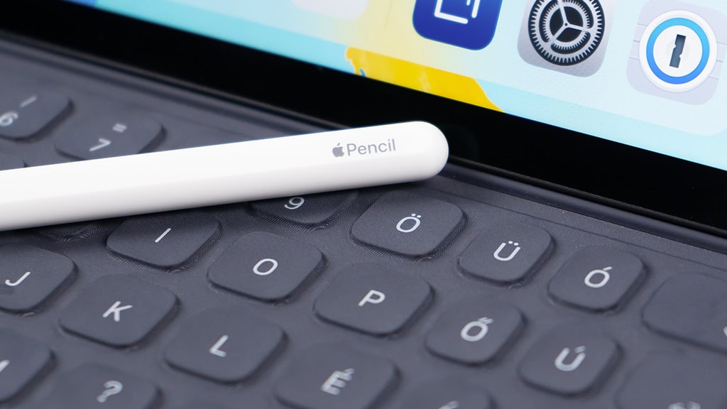 Apple Pencil on keyboard, digital health and tech tools, innovative medical devices, modern healthcare solutions, optometry equipment.