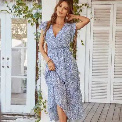 Stylish summer dress with a blue leopard print, V-neckline, short flutter sleeves, adjustable waist, and high-low hem perfect for casual outings and beachwear.