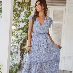 Woman wearing stylish blue animal print maxi dress with short sleeves and V-neckline, perfect for casual summer outings and beach vacations.