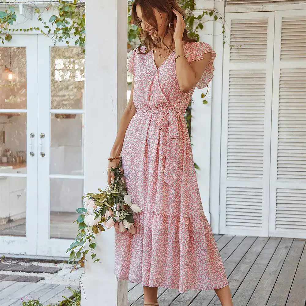 Elegant pink floral maxi dress with ruffled sleeves, perfect for warm weather and outdoor occasions. Features a comfortable elastic waist and flowing skirt for a flattering fit.