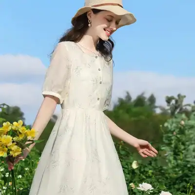 Beautiful light-colored womenโs summer dress with floral embroidery, short sleeves, button-up front, perfect for outdoor activities and fashion statements.