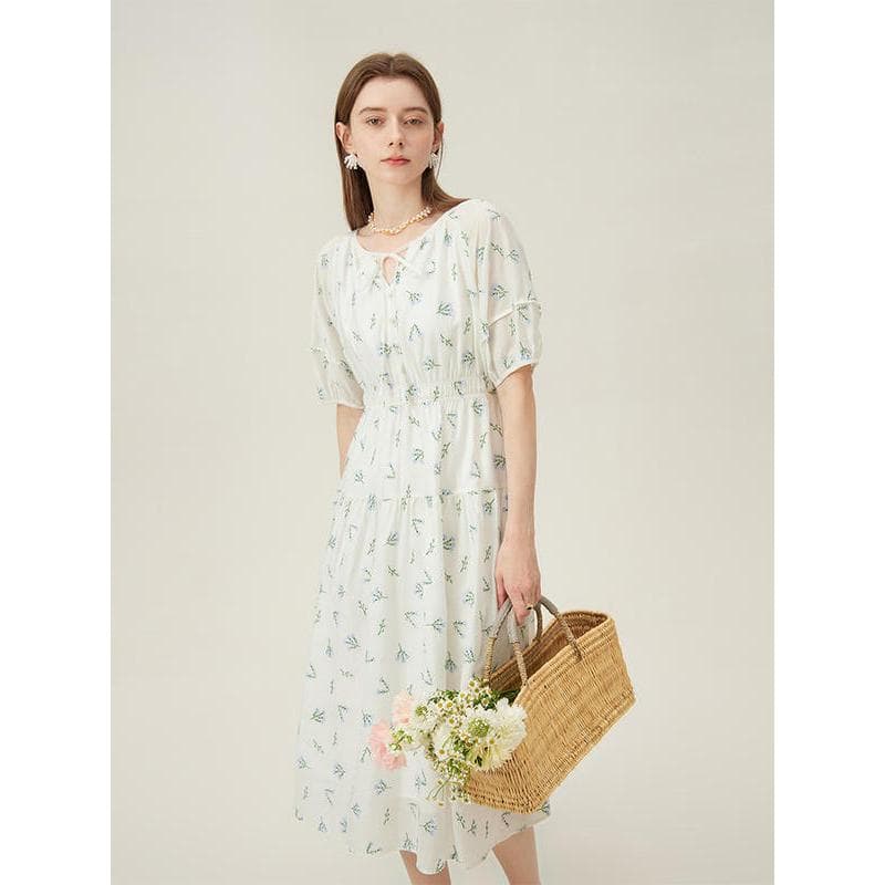 Elegant white summer dress with delicate floral print, perfect for casual outings or special occasions. Made with high-quality fabric for comfort and style.