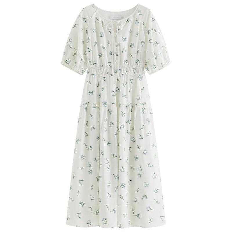 Floral printed dress with puffed sleeves, button details, and a flowy, maxi-length design, ideal for summer and casual occasions. Perfect for a stylish, comfortable look.