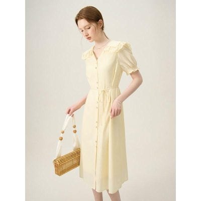 Beautiful pastel yellow dress with puff sleeves, button-down front, and waist tie, perfect for casual or dressy occasions. Crafted with lightweight fabric for comfort and style.