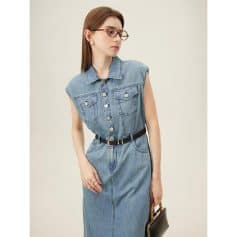 Stylish women's denim dress with sleeveless design, button-up front, and waist belt for a trendy, casual look. Perfect for fashion-forward occasions and everyday wear.