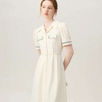 Stylish cream-colored dress featuring puffed short sleeves, classic collar, and button-down front, perfect for fashionable women seeking comfortable, chic clothing options.