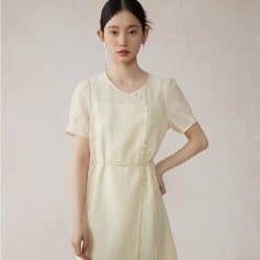 Elegant ivory satin dress with a flattering fit and delicate button details, perfect for formal occasions, stylish events, or office wear. Luxurious and comfortable for all-day elegance.