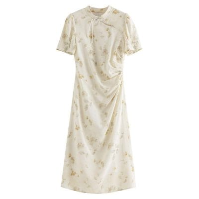 Beautiful cream-colored floral dress with short puff sleeves, a tie-up neckline, and a draped design, perfect for stylish occasions and comfortable wear.