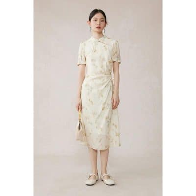 Beautiful silk midi dress with subtle floral pattern, short sleeves, and a stylish tie collar for sophisticated look. Perfect for casual or semi-formal occasions.