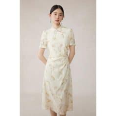 Elegant satin dress with floral pattern, short sleeves, and feminine bow tie detail, perfect for stylish occasions.