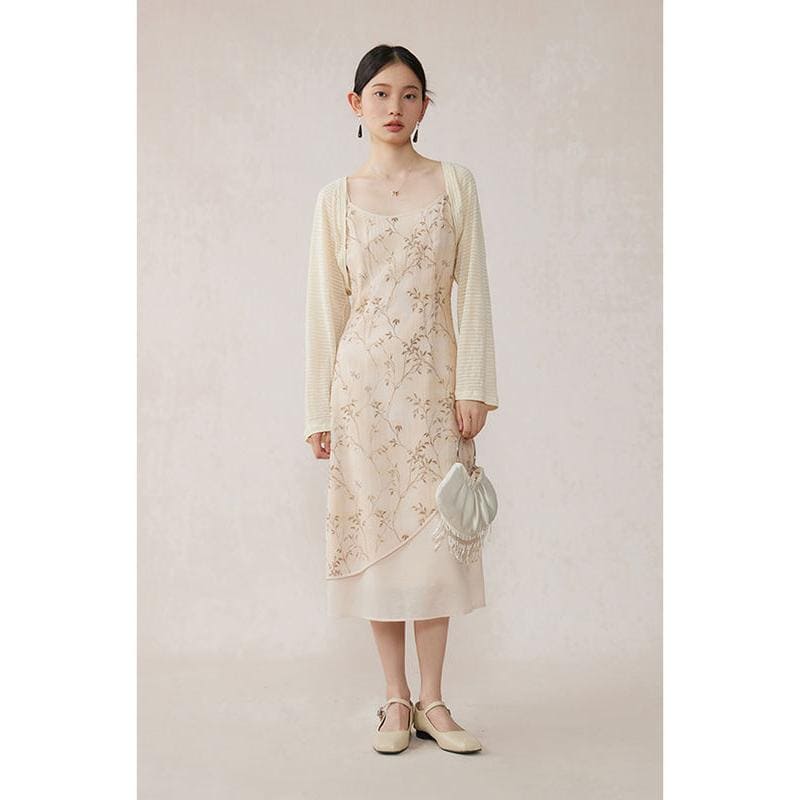 Stylish woman wearing a beige floral lace dress paired with a cozy cream cardigan, holding a trendy white purse, showcasing timeless fashion essentials at Monalisa Store.