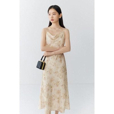 Elegant silk maxi dress in a soft beige hue, perfect for summer and special occasions. Features delicate spaghetti straps, a flowy silhouette, and a luxurious feel.