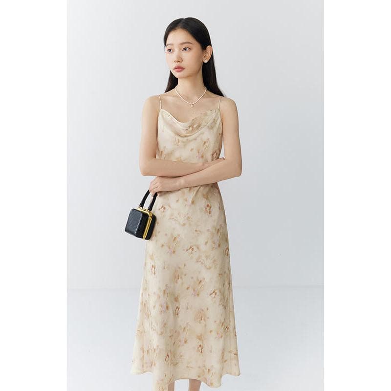 Elegant silk maxi dress in a soft beige hue, perfect for summer and special occasions. Features delicate spaghetti straps, a flowy silhouette, and a luxurious feel.