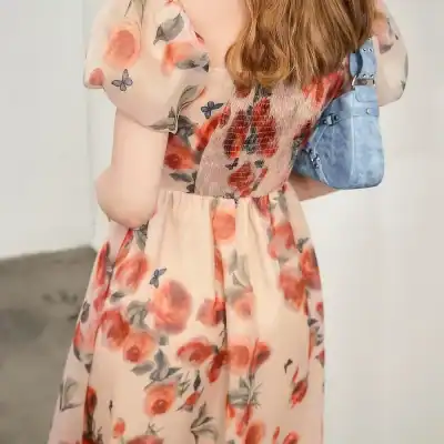 Stylish floral dress with elegant print, perfect for spring and summer, accessorized with trendy blue handbag, available at Monalisa Store for women's fashion.