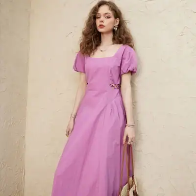 Stylish pink dress with puffy sleeves and side cutout, perfect for casual or semi-formal occasions, featuring comfortable fabric and trendy design.