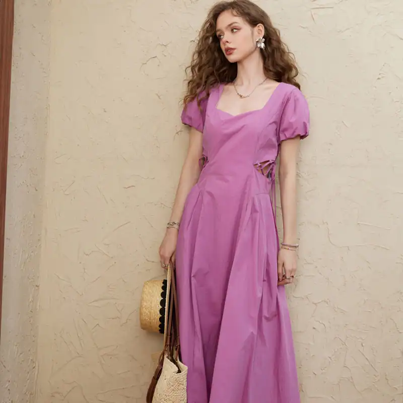 Stylish pink maxi dress with puff sleeves and cut-out details, perfect for summer outings and casual occasions. Made from lightweight fabric for comfort and elegance.