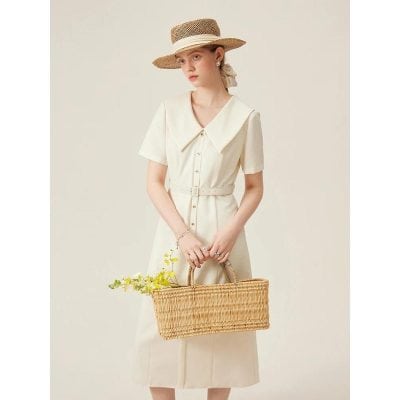 Stylish cream-colored dress with a wide collar and button-down front, perfect for summer outings. Made from high-quality fabric, offering comfort and a chic look.