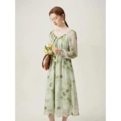 Stylish women's dress in light green with floral print, puff sleeves, and a flowy silhouette, perfect for casual or semi-formal occasions.
