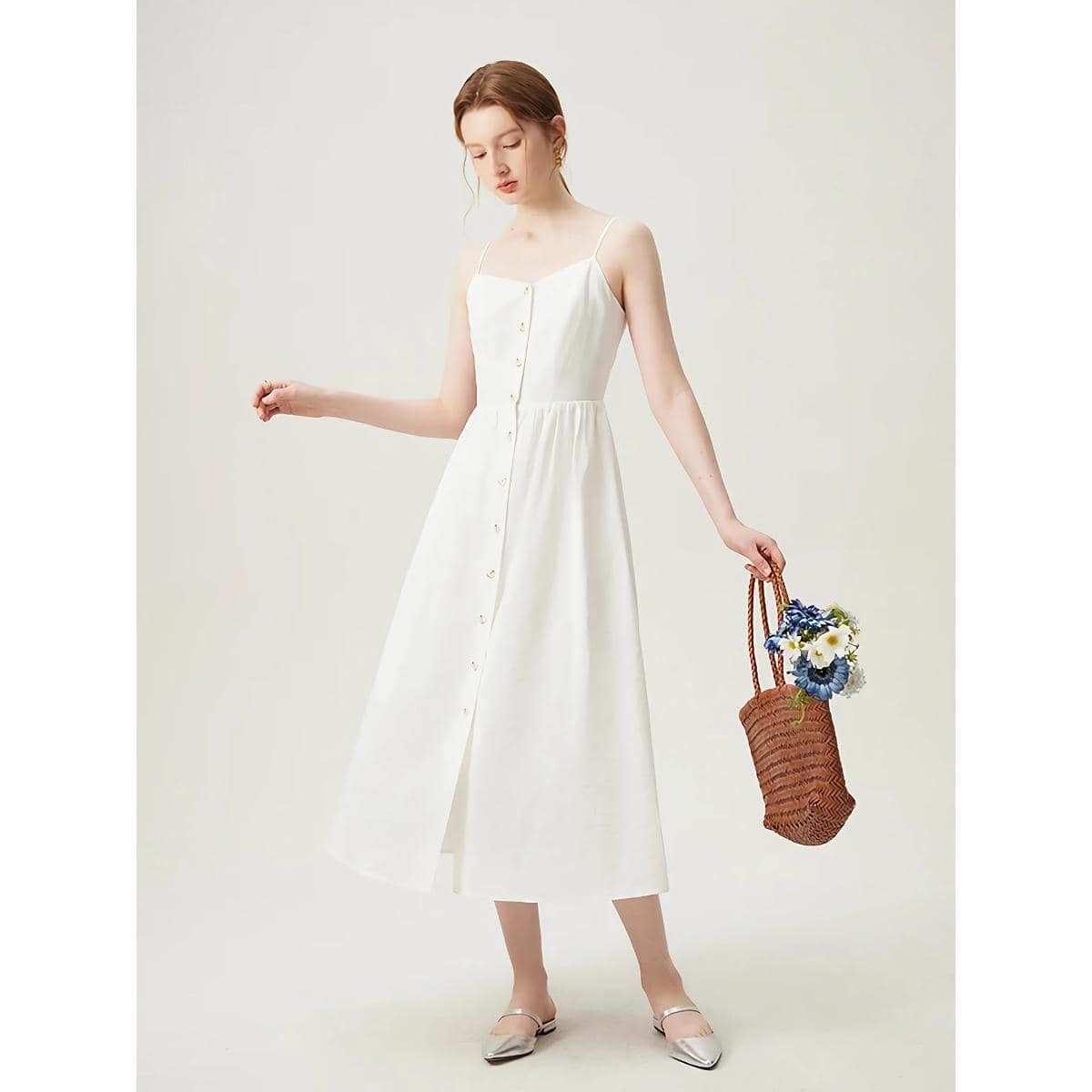 A stylish white sleeveless maxi dress with button details, perfect for summer outings and casual elegance. Featuring a flattering fit and lightweight fabric for comfortable wear.