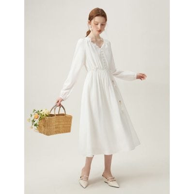 This stylish white midi dress features a button-down front, long sleeves, and an elastic waist, perfect for casual or daytime wear. Made from lightweight fabric, it combines comfort and elegance, suitable for summer outings or relaxed occasions. A versatile addition to any wardrobe, embodying timeless style.