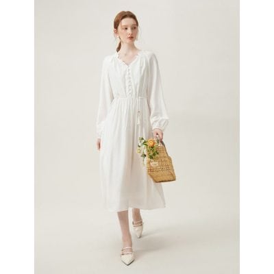 A stylish white maxi dress featuring long, flowy sleeves, a cinched waist, and button-down front, perfect for summer wear and elegant occasions, available at Monalisa Medical Store.
