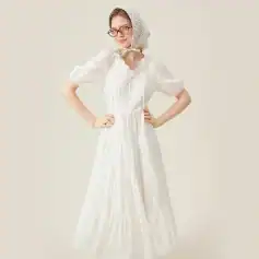 Fashionable white maxi dress with puff sleeves, button-front, and tiered skirt, perfect for summer and chic occasions at Monalisa Medical store.