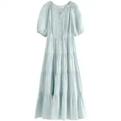 Light blue, flowy maxi dress with puff sleeves, button details, perfect for casual or beachwear.