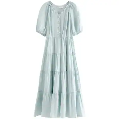 Light blue, flowy maxi dress with puff sleeves, button details, perfect for casual or beachwear.
