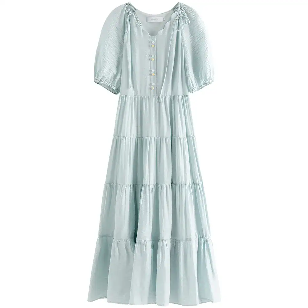 Light blue, flowy maxi dress with puff sleeves, button details, perfect for casual or beachwear.