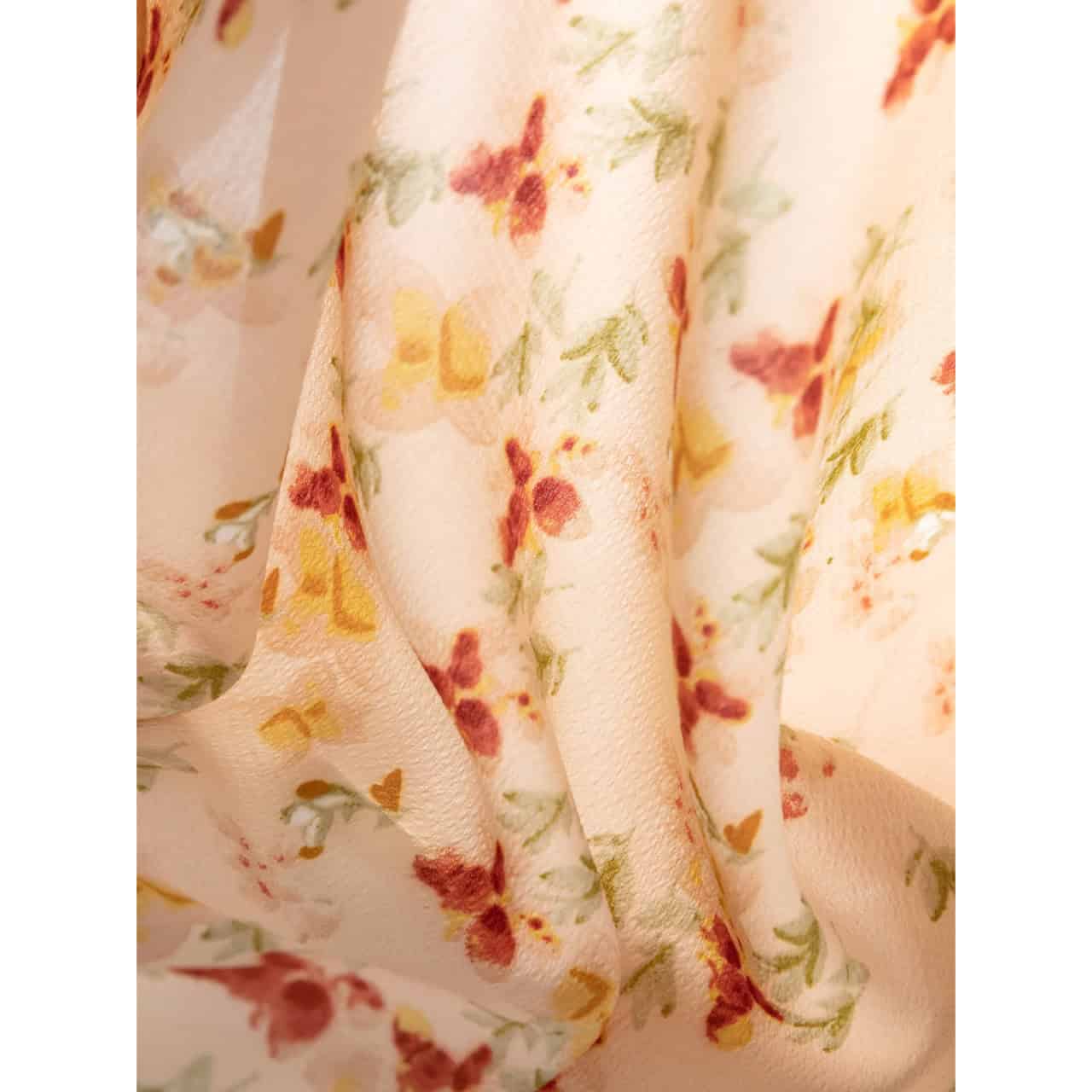 Close-up of a soft, feminine floral dress fabric with pastel-colored flower patterns, perfect for stylish, comfortable wear.