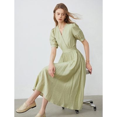 Stylish olive-green maxi dress with puff sleeves, V-neck, and cinched waist perfect for fashion-forward women. Suitable for casual outings or special occasions.