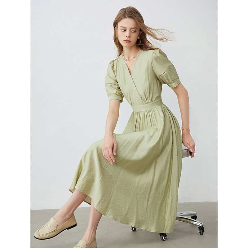 Stylish olive-green maxi dress with puff sleeves, V-neck, and cinched waist perfect for fashion-forward women. Suitable for casual outings or special occasions.