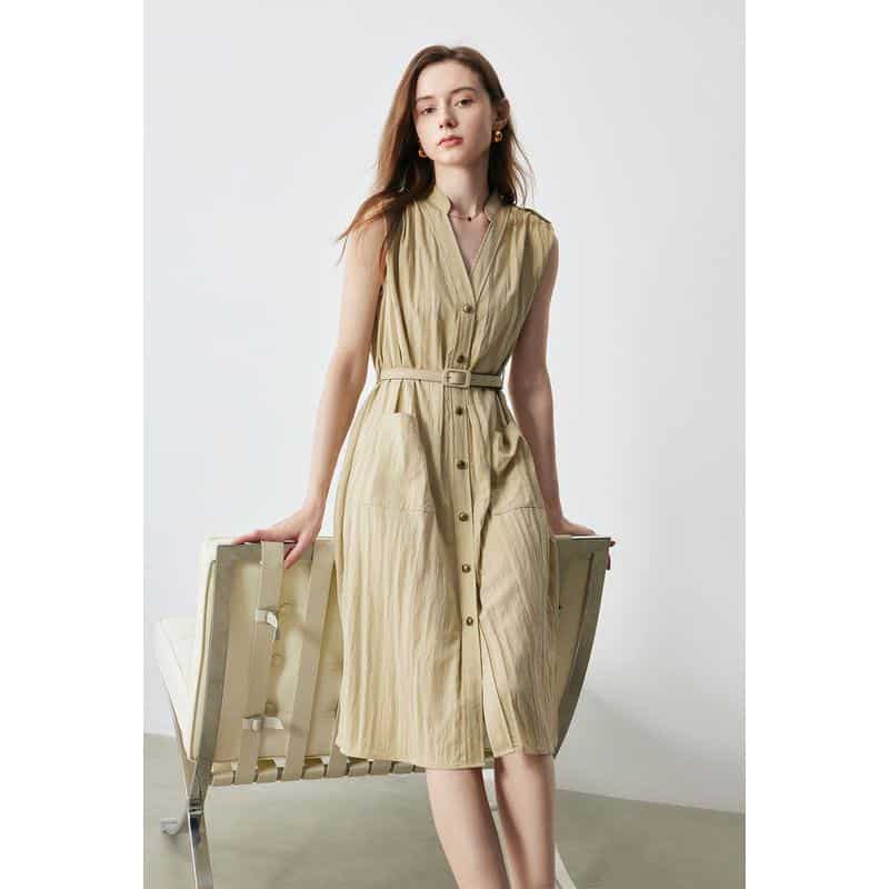 Elegant sleeveless beige midi dress with a front button design, waist belt, and comfortable fabric, perfect for casual and semi-formal occasions.
