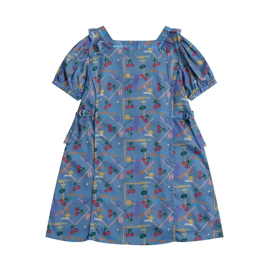 Bright blue children's dress with playful cherry and cartoon character pattern, puff sleeves, ruffled shoulder details, perfect for kids' casual or party wear.