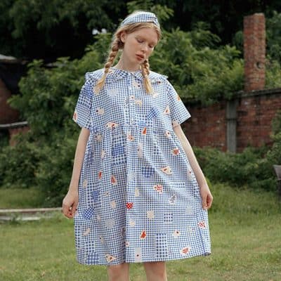 Stylish women's dress with a blue and white checkered pattern and playful fruit and flower prints, perfect for casual outings and garden parties.