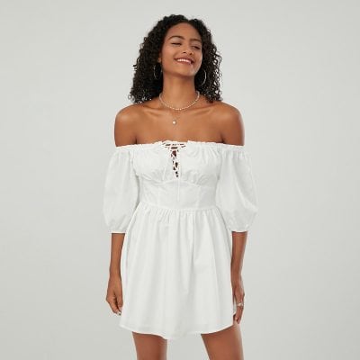 Stylish white off-shoulder dress with lace-up front and puff sleeves, perfect for summer and special occasions.
