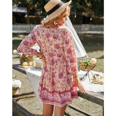 Stylish floral summer dress with vibrant pink and red patterns, perfect for outdoor gatherings and warm weather. Made from lightweight, breathable fabric for comfort and style.