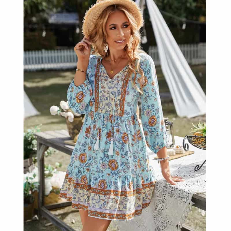 Elegant boho floral dress with lightweight fabric, v-neck, 3/4 sleeves, and tassel details, perfect for summer and outdoor events.