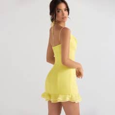 Elegant yellow summer dress with ruffled hem, spaghetti straps, and fitted silhouette, perfect for casual outings or special occasions.