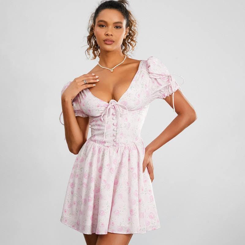 Fashionable women's pink floral dress with puff sleeves, front tie detail, and flattering fit, suitable for all-day wear and stylish outings.