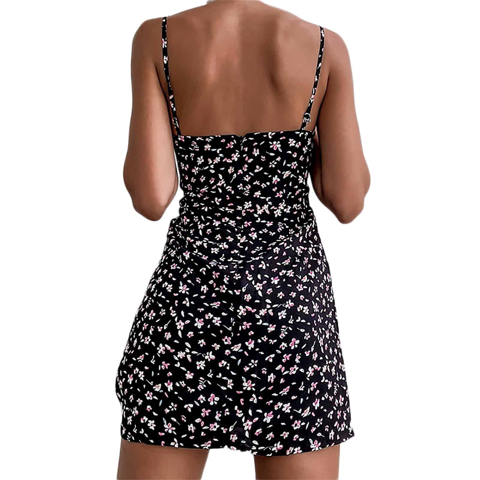 A stylish black dress with pink and white floral patterns, featuring thin spaghetti straps perfect for summer and casual outings.