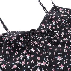 Brightly colored floral dress featuring a black background and pink, white, and blue flower print. Includes adjustable spaghetti straps and a tied bow at the waist for a flattering fit. Ideal for spring or summer fashion.