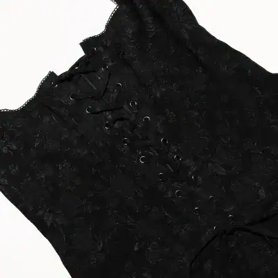 Close-up of a black lace corset featuring intricate floral lace design and metal eyelet lace-up front, perfect for stylish fashion or special occasion wear.