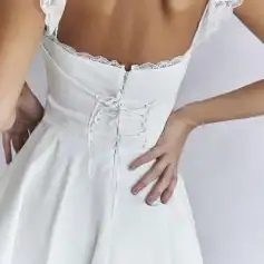 Beautiful white wedding gown with lace trim and adjustable corset, perfect for bridal wear and special occasions.