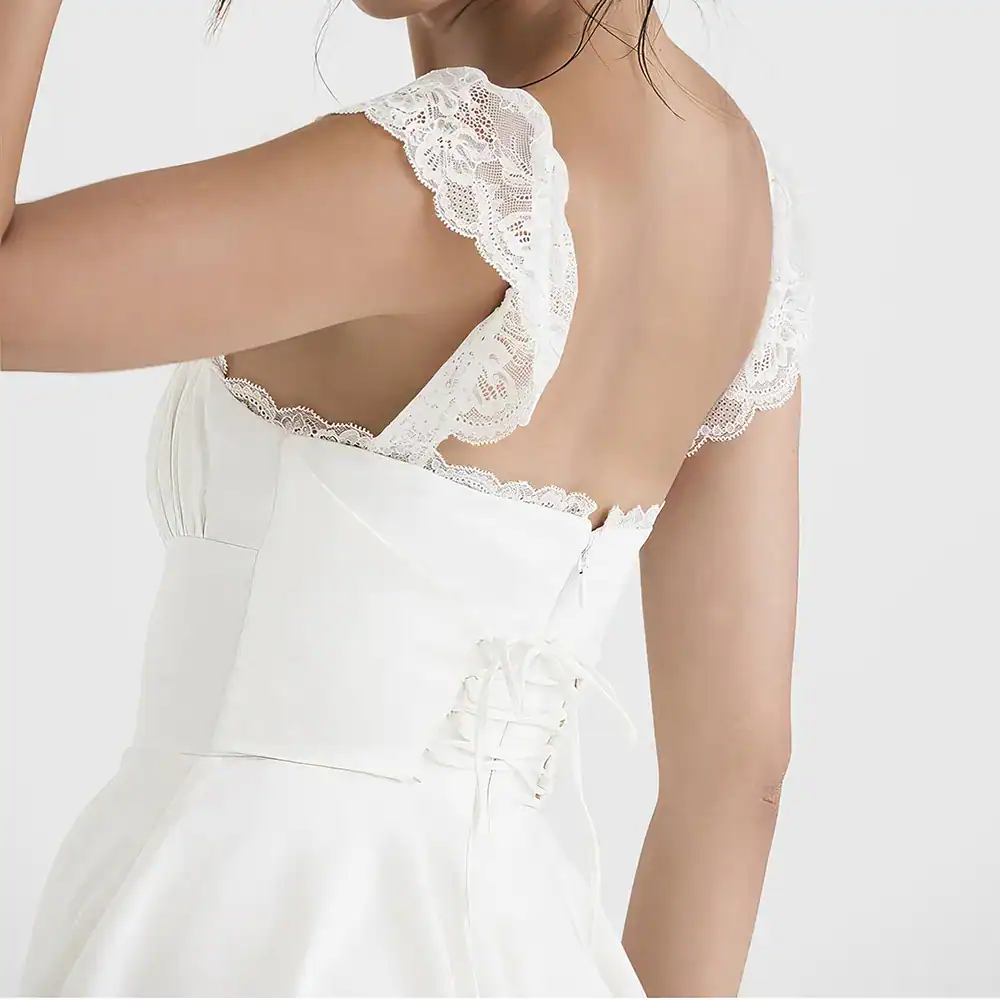 Stylish white wedding dress featuring delicate lace shoulder details and a fitted waist for a timeless bridal look. Perfect for weddings and special occasions.