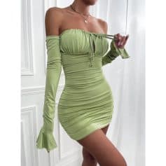 Close-up of a stylish, fitted lime green off-shoulder dress with long sleeves and ruched fabric, perfect for trendy fashion and special occasions.