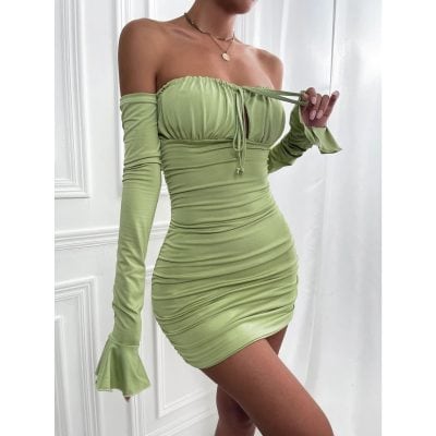 Close-up of a stylish, fitted lime green off-shoulder dress with long sleeves and ruched fabric, perfect for trendy fashion and special occasions.